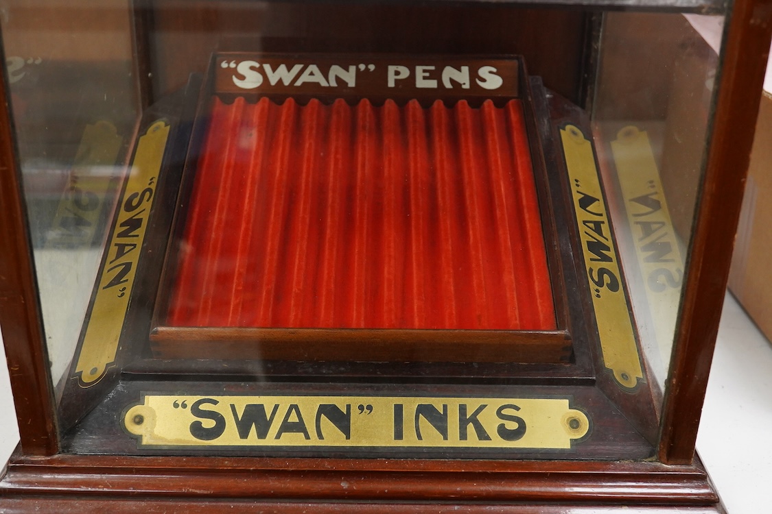 A rare complete Mabie Todd & Co. Swan pen cabinet with original signage and trays to hold twenty four pens, with key for lockable rear door
